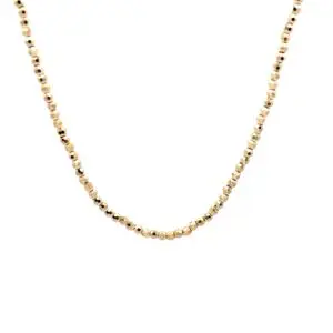 Delicate gold beaded necklace on white background