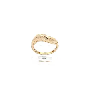 Gold honeycomb patterned ring on display