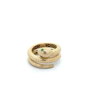 Gold coiled snake ring with emerald eyes
