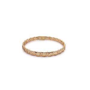 Textured gold bangle bracelet on white