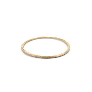 thin gold bangle on white background