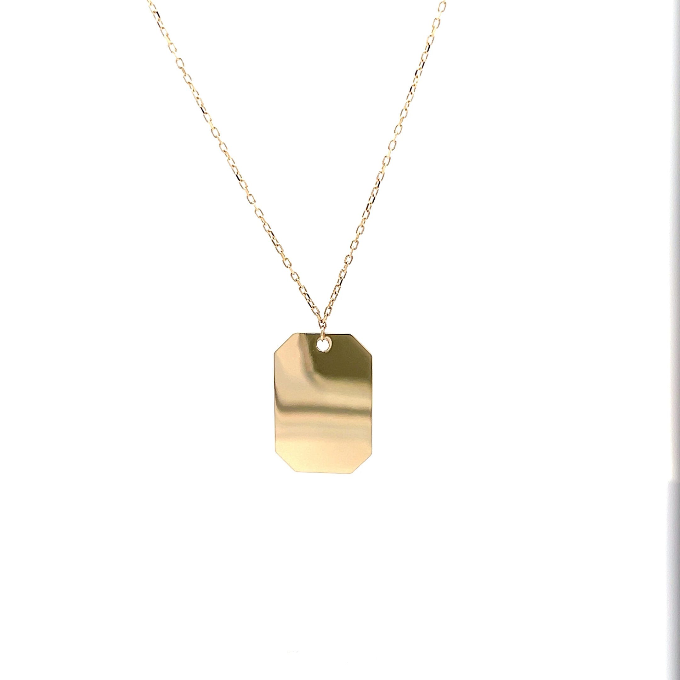 Gold rectangular pendant necklace on chain
